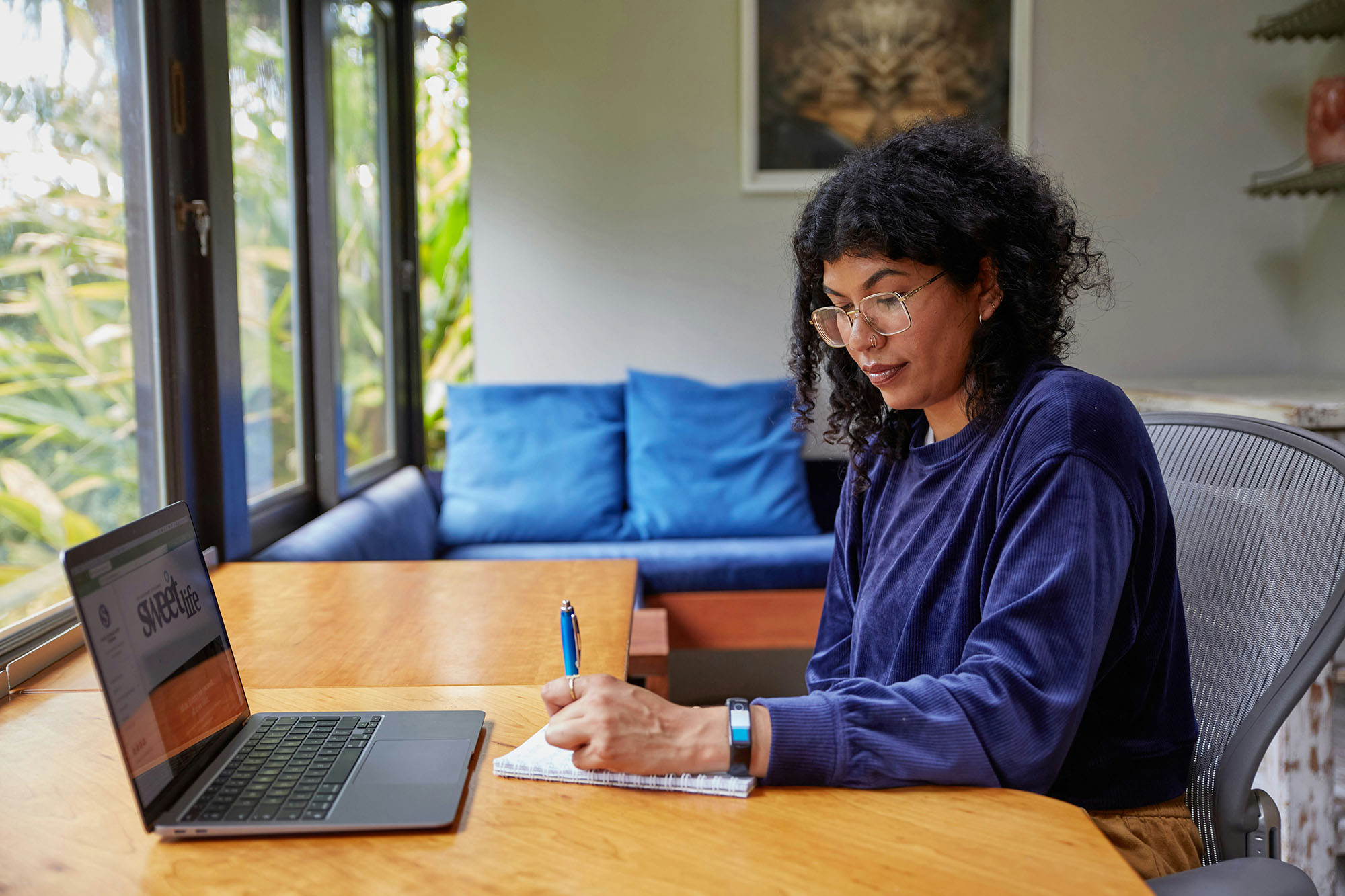 person sitting in front of a laptop writing